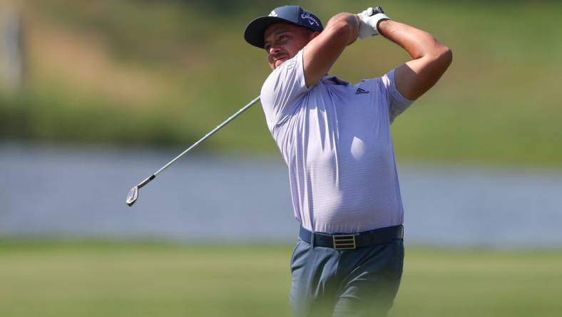 Jun 26, 2022; Cromwell, Connecticut, USA; Xander Schauffele plays a shot from the fairway of the 13th hole during the final round of the Travelers Championship golf tournament. Mandatory Credit: Vincent Carchietta-USA TODAY Sports