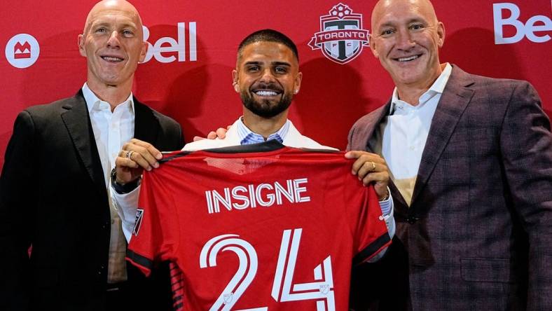 Jun 27, 2022; Toronto, Ontario, Canada; Toronto FC designated player Lorenzo Insigne (center) with president Bill Manning (right) and head coach Bob Bradley (left) at a press conference at BMO Field. Mandatory Credit: John E. Sokolowski-USA TODAY Sports