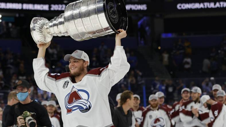 Jun 26, 2022; Tampa, Florida, USA; Colorado Avalanche left wing Andre Burakovsky (95) celebrates with the Stanley Cup after the Avalanche game against the Tampa Bay Lightning in game six of the 2022 Stanley Cup Final at Amalie Arena. Mandatory Credit: Geoff Burke-USA TODAY Sports