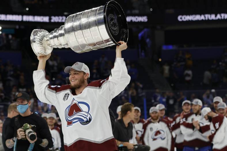 Jun 26, 2022; Tampa, Florida, USA; Colorado Avalanche left wing Andre Burakovsky (95) celebrates with the Stanley Cup after the Avalanche game against the Tampa Bay Lightning in game six of the 2022 Stanley Cup Final at Amalie Arena. Mandatory Credit: Geoff Burke-USA TODAY Sports
