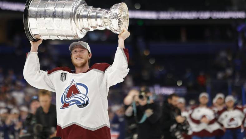 Jun 26, 2022; Tampa, Florida, USA; Colorado Avalanche defenseman Josh Manson (42) celebrates with the Stanley Cup after the Avalanche game against the Tampa Bay Lightning in game six of the 2022 Stanley Cup Final at Amalie Arena. Mandatory Credit: Geoff Burke-USA TODAY Sports