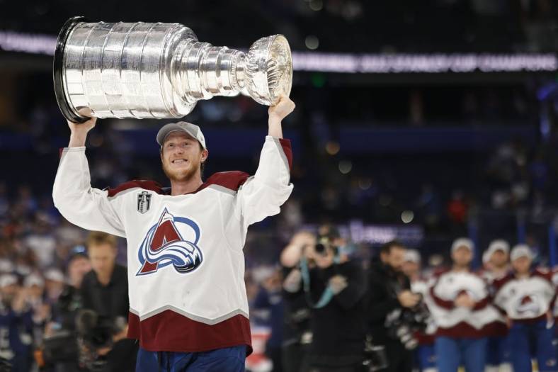 Jun 26, 2022; Tampa, Florida, USA; Colorado Avalanche defenseman Josh Manson (42) celebrates with the Stanley Cup after the Avalanche game against the Tampa Bay Lightning in game six of the 2022 Stanley Cup Final at Amalie Arena. Mandatory Credit: Geoff Burke-USA TODAY Sports