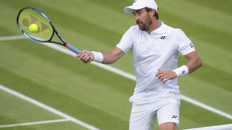 Jun 29, 2022; London, United Kingdom; Steve Johnson (USA) returns a shot during his second round match against Ryan Peniston (GBR) on day three at All England Lawn Tennis and Croquet Club. Mandatory Credit: Susan Mullane-USA TODAY Sports