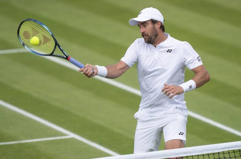 Jun 29, 2022; London, United Kingdom; Steve Johnson (USA) returns a shot during his second round match against Ryan Peniston (GBR) on day three at All England Lawn Tennis and Croquet Club. Mandatory Credit: Susan Mullane-USA TODAY Sports