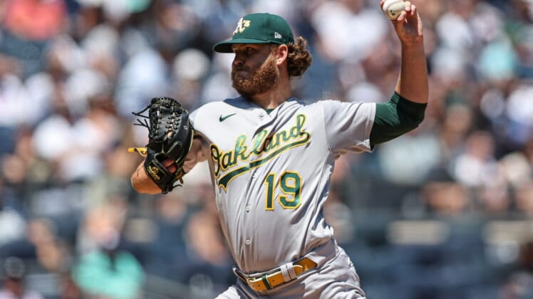 Jun 29, 2022; Bronx, New York, USA; Oakland Athletics starting pitcher Cole Irvin (19) delivers a pitch during the first inning against the New York Yankees at Yankee Stadium. Mandatory Credit: Vincent Carchietta-USA TODAY Sports