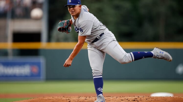Jun 29, 2022; Denver, Colorado, USA; Los Angeles Dodgers starting pitcher Julio Urias (7) pitches in the first inning against the Colorado Rockies at Coors Field. Mandatory Credit: Isaiah J. Downing-USA TODAY Sports
