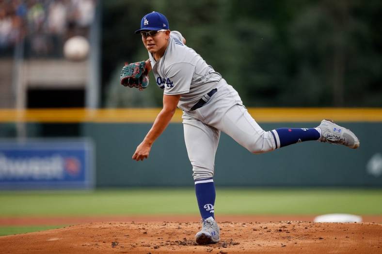 Jun 29, 2022; Denver, Colorado, USA; Los Angeles Dodgers starting pitcher Julio Urias (7) pitches in the first inning against the Colorado Rockies at Coors Field. Mandatory Credit: Isaiah J. Downing-USA TODAY Sports