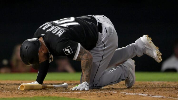 Jun 29, 2022; Anaheim, California, USA;  Chicago White Sox third baseman Yoan Moncada (10) hits the ground after fouling a ball off his foot in the eighth inning against the Los Angeles Angels at Angel Stadium. Mandatory Credit: Jayne Kamin-Oncea-USA TODAY Sports