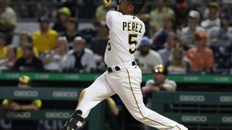 Jun 30, 2022; Pittsburgh, Pennsylvania, USA; Pittsburgh Pirates catcher Michael Perez (5) hits a solo home run against the Milwaukee Brewers during the eighth inning at PNC Park. Mandatory Credit: Charles LeClaire-USA TODAY Sports