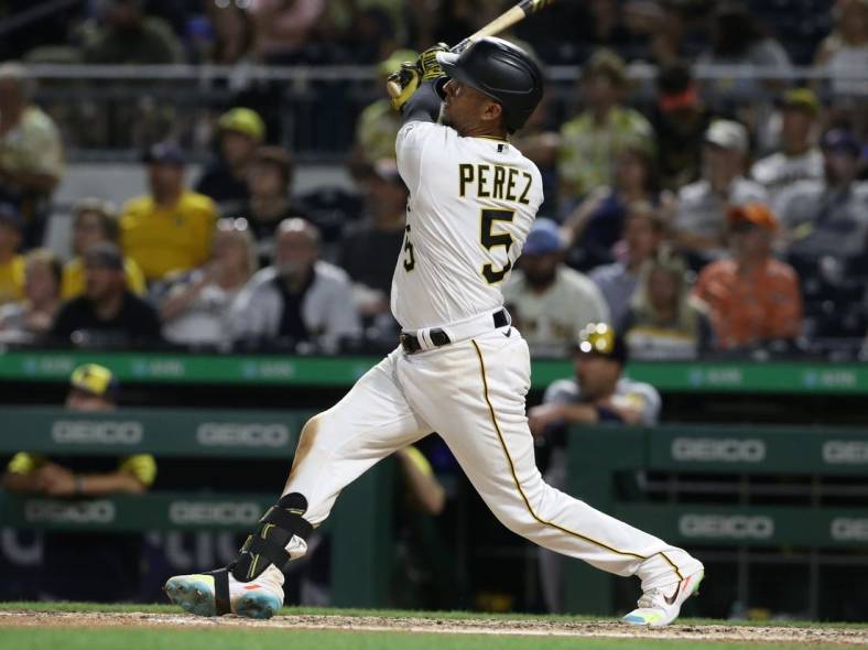Jun 30, 2022; Pittsburgh, Pennsylvania, USA; Pittsburgh Pirates catcher Michael Perez (5) hits a solo home run against the Milwaukee Brewers during the eighth inning at PNC Park. Mandatory Credit: Charles LeClaire-USA TODAY Sports