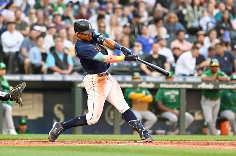 Jun 30, 2022; Seattle, Washington, USA; Seattle Mariners center fielder Julio Rodriguez (44) hits a home run against the Oakland Athletics during the third inning at T-Mobile Park. Mandatory Credit: Steven Bisig-USA TODAY Sports