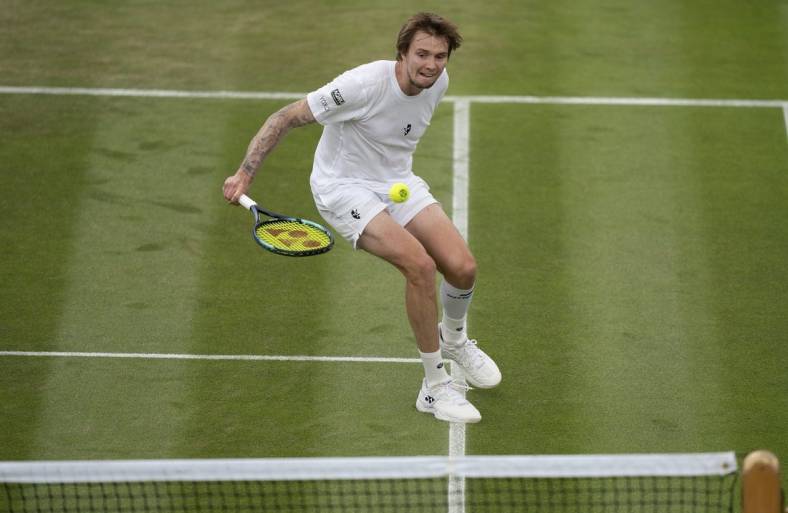 Jul 1, 2022; London, United Kingdom; Alexander Bublik (KAZ) returns a shot during his match against Frances Tiafoe (USA) on day five at All England Lawn Tennis and Croquet Club. Mandatory Credit: Susan Mullane-USA TODAY Sports