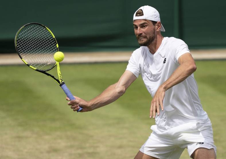 Jul 1, 2022; London, United Kingdom; Maxime Cressy (USA) returns a shot during his match against Jack Sock (USA) on day five at All England Lawn Tennis and Croquet Club. Mandatory Credit: Susan Mullane-USA TODAY Sports