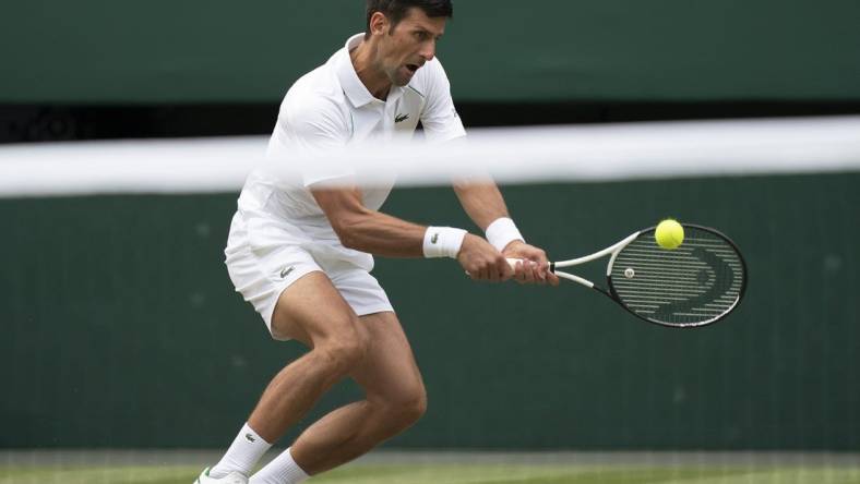 Jul 1, 2022; London, United Kingdom; Novak Djokovic (SRB) returns a shot during his match against Miomir Kecmanovic (SRB) on day five at All England Lawn Tennis and Croquet Club. Mandatory Credit: Susan Mullane-USA TODAY Sports