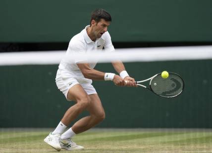 Jul 1, 2022; London, United Kingdom; Novak Djokovic (SRB) returns a shot during his match against Miomir Kecmanovic (SRB) on day five at All England Lawn Tennis and Croquet Club. Mandatory Credit: Susan Mullane-USA TODAY Sports
