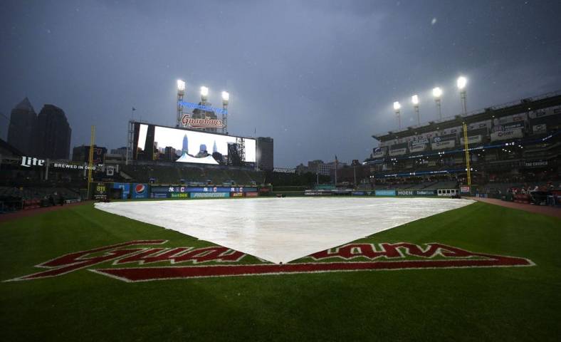 Jul 1, 2022; Cleveland, Ohio, USA; The tarp covers the field as the game between the Cleveland Guardians and the New York Yankees is delayed at Progressive Field. Mandatory Credit: Ken Blaze-USA TODAY Sports