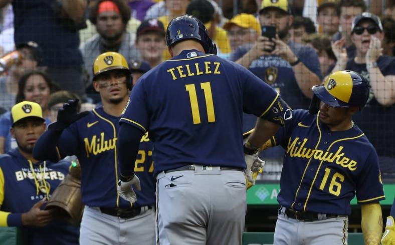 Jul 1, 2022; Pittsburgh, Pennsylvania, USA;  Milwaukee Brewers shortstop Willy Adames (27) and second baseman Kolten Wong (16) congratulate first baseman Rowdy Tellez (11) on his three run home run against the Pittsburgh Pirates during the second inning at PNC Park. Mandatory Credit: Charles LeClaire-USA TODAY Sports