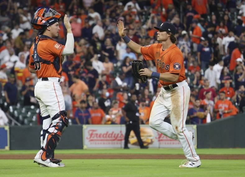 Jul 1, 2022; Houston, Texas, USA; Houston Astros catcher Korey Lee (38) and Houston Astros center fielder Jake Meyers (6) celebrate defeating the Los Angeles Angels at Minute Maid Park. Mandatory Credit: Thomas Shea-USA TODAY Sports
