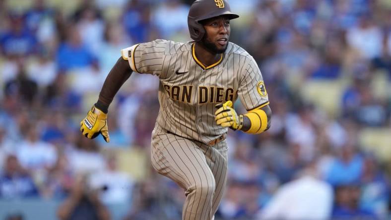 Jul 1, 2022; Los Angeles, California, USA; San Diego Padres left fielder Jurickson Profar (10) runs toward first base on a double in the first inning against the Los Angeles Dodgers at Dodger Stadium. Mandatory Credit: Kirby Lee-USA TODAY Sports