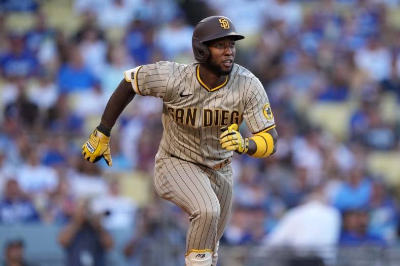 Jul 1, 2022; Los Angeles, California, USA; San Diego Padres left fielder Jurickson Profar (10) runs toward first base on a double in the first inning against the Los Angeles Dodgers at Dodger Stadium. Mandatory Credit: Kirby Lee-USA TODAY Sports