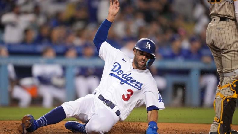 Jul 1, 2022; Los Angeles, California, USA; Los Angeles Dodgers left fielder Chris Taylor (3) slides into home plate to score in the eighth inning against the San Diego Padres at Dodger Stadium. Mandatory Credit: Kirby Lee-USA TODAY Sports