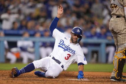 Jul 1, 2022; Los Angeles, California, USA; Los Angeles Dodgers left fielder Chris Taylor (3) slides into home plate to score in the eighth inning against the San Diego Padres at Dodger Stadium. Mandatory Credit: Kirby Lee-USA TODAY Sports