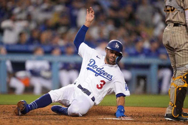 Jul 1, 2022; Los Angeles, California, USA; Los Angeles Dodgers left fielder Chris Taylor (3) slides into home plate to score in the eighth inning against the San Diego Padres at Dodger Stadium. Mandatory Credit: Kirby Lee-USA TODAY Sports