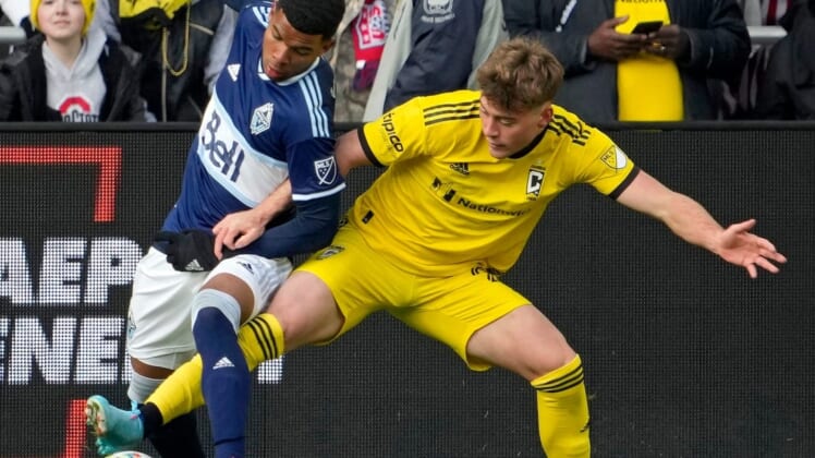 Vancouver Whitecaps midfielder Pedro Vite (45) and Columbus Crew midfielder Aidan Morris (21) compete for a ball during the second half of Saturday's season opener at Lower.com field in Columbus, Oh., on February 26, 2022.Ceb Crew 0227 Bjp 37