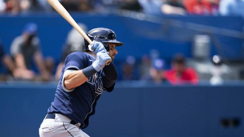 Jul 2, 2022; Toronto, Ontario, CAN; Tampa Bay Rays center fielder Kevin Kiermaier (39) hits a single against the Toronto Blue Jays during the fifth inning at Rogers Centre. Mandatory Credit: Nick Turchiaro-USA TODAY Sports