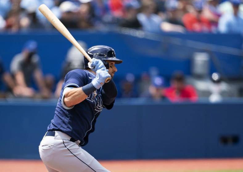 Jul 2, 2022; Toronto, Ontario, CAN; Tampa Bay Rays center fielder Kevin Kiermaier (39) hits a single against the Toronto Blue Jays during the fifth inning at Rogers Centre. Mandatory Credit: Nick Turchiaro-USA TODAY Sports
