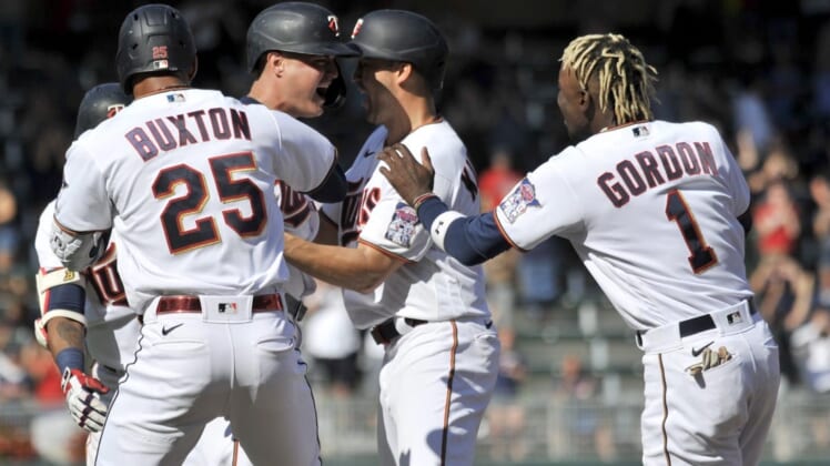 Jul 2, 2022; Minneapolis, Minnesota, USA; Minnesota Twins pinch hitter Jose Miranda (left center) reacts with center fielder Nick Gordon (1), designated hitter Byron Buxton (25), left fielder Alex Kirilloff (right center) and teammates after hitting a walk off single against Baltimore Orioles relief pitcher Jorge Lopez (not pictured) during the ninth inning at Target Field. Mandatory Credit: Jeffrey Becker-USA TODAY Sports