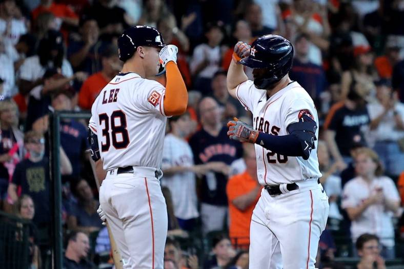 Jul 2, 2022; Houston, Texas, USA; Houston Astros left fielder Chas McCormick (20, right) is congratulated by Houston Astros catcher Korey Lee (38, left) after hitting a home run against the Los Angeles Angels during the seventh inning at Minute Maid Park. Mandatory Credit: Erik Williams-USA TODAY Sports