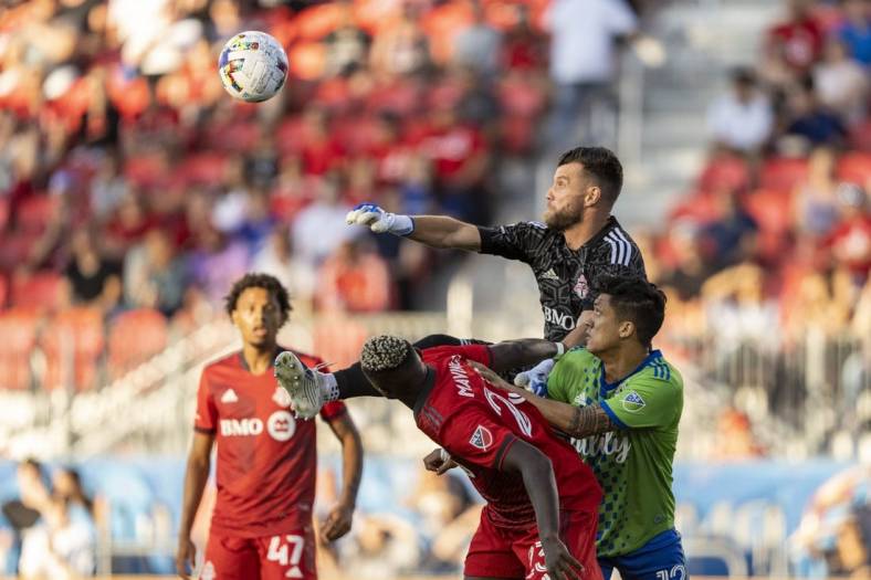 Jul 2, 2022; Toronto, Ontario, CAN; Toronto FC goalkeeper Quentin Westberg (16) makes a save against Seattle Sounders forward Fredy Montero (12) during the first half at BMO Field. Mandatory Credit: Kevin Sousa-USA TODAY Sports
