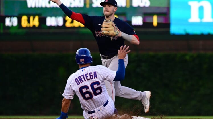 Jul 2, 2022; Chicago, Illinois, USA; Boston Red Sox second baseman Trevor Story (10) turns a double play in the third inning against the Chicago Cubs at Wrigley Field. Mandatory Credit: Quinn Harris-USA TODAY