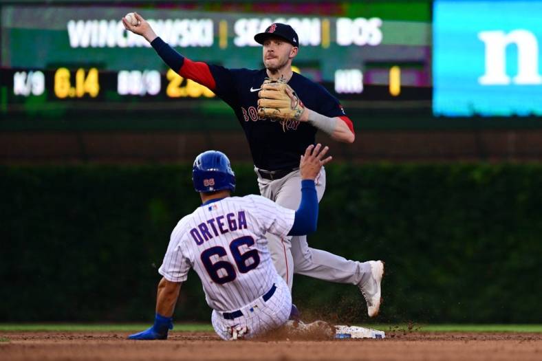 Jul 2, 2022; Chicago, Illinois, USA; Boston Red Sox second baseman Trevor Story (10) turns a double play in the third inning against the Chicago Cubs at Wrigley Field. Mandatory Credit: Quinn Harris-USA TODAY