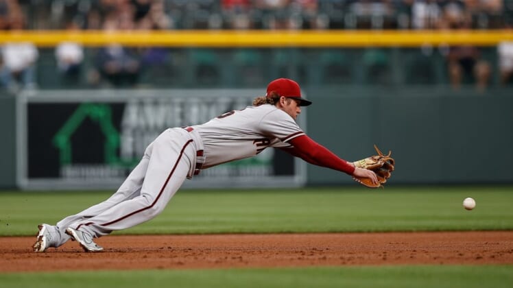 Jul 2, 2022; Denver, Colorado, USA; Arizona Diamondbacks third baseman Jake Hager (16) is unable to field a ground ball in the first inning against the Colorado Rockies at Coors Field. Mandatory Credit: Isaiah J. Downing-USA TODAY Sports