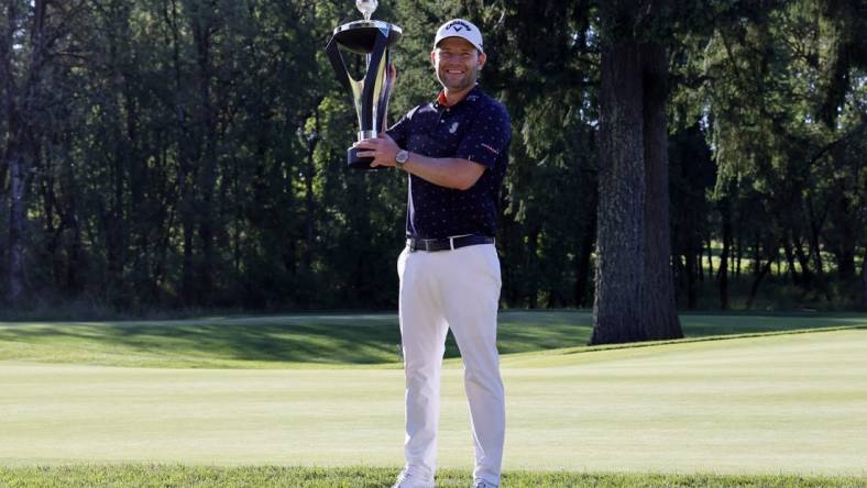 Jul 2, 2022; Portland, Oregon, USA; Branden Grace poses with the trophy after winning the LIV Golf tournament at Pumpkin Ridge Golf Club. Mandatory Credit: Soobum Im-USA TODAY Sports