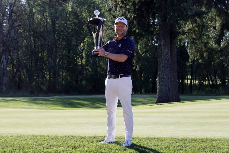 Jul 2, 2022; Portland, Oregon, USA; Branden Grace poses with the trophy after winning the LIV Golf tournament at Pumpkin Ridge Golf Club. Mandatory Credit: Soobum Im-USA TODAY Sports