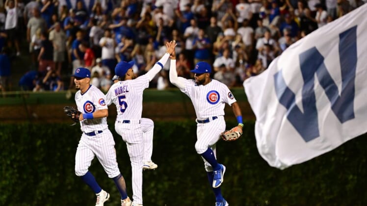 Jul 2, 2022; Chicago, Illinois, USA; Chicago Cubs left fielder Ian Happ (8), Chicago Cubs center fielder Narciso Crook (24), and Chicago Cubs center fielder Christopher Morel (5) celebrate after the 3-1 win against the Boston Red Sox at Wrigley Field. Mandatory Credit: Quinn Harris-USA TODAY Sports