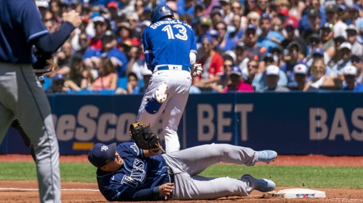Jul 3, 2022; Toronto, Ontario, CAN; Tampa Bay Rays first baseman Ji-Man Choi (26) tags out Toronto Blue Jays left fielder Lourdes Gurriel Jr. (13) at first base during the second inning at Rogers Centre. Mandatory Credit: Kevin Sousa-USA TODAY Sports