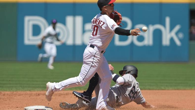 Jul 3, 2022; Cleveland, Ohio, USA; Cleveland Guardians second baseman Andres Gimenez (0) forces out New York Yankees third baseman Josh Donaldson (28) during the fourth inning at Progressive Field. Mandatory Credit: Ken Blaze-USA TODAY Sports