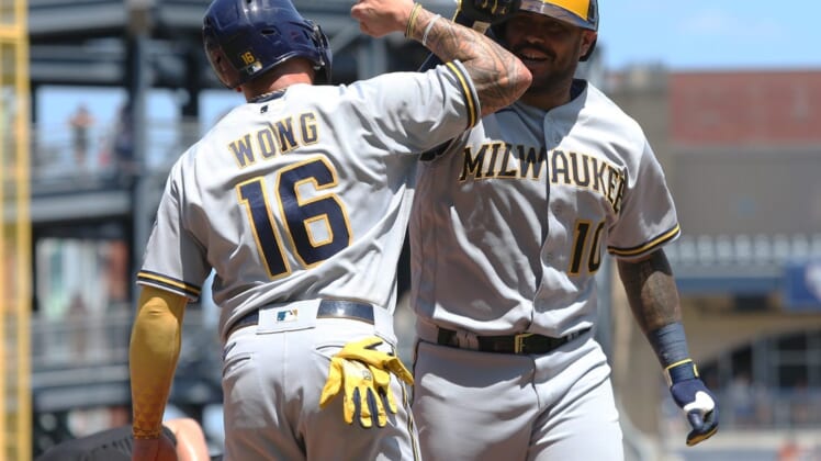 Jul 3, 2022; Pittsburgh, Pennsylvania, USA;  Milwaukee Brewers second baseman Kolten Wong (16) celebrates with catcher Omar Narvaez (10) as he crosses home plate on a two-run home run against the Pittsburgh Pirates during the fifth inning at PNC Park. Mandatory Credit: Charles LeClaire-USA TODAY Sports
