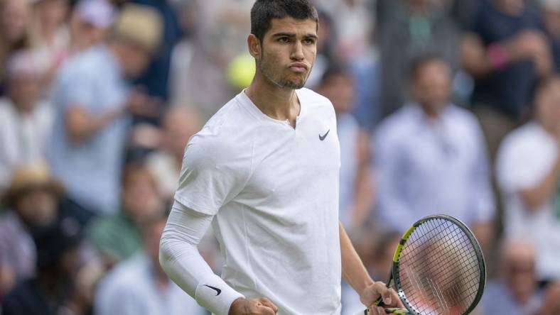 Jul 3, 2022; London, United Kingdom; Carlos Alcaraz (ESP) reacts to a point during his match against Jannik Sinner (ITA) on day seven at All England Lawn Tennis and Croquet Club. Mandatory Credit: Susan Mullane-USA TODAY Sports