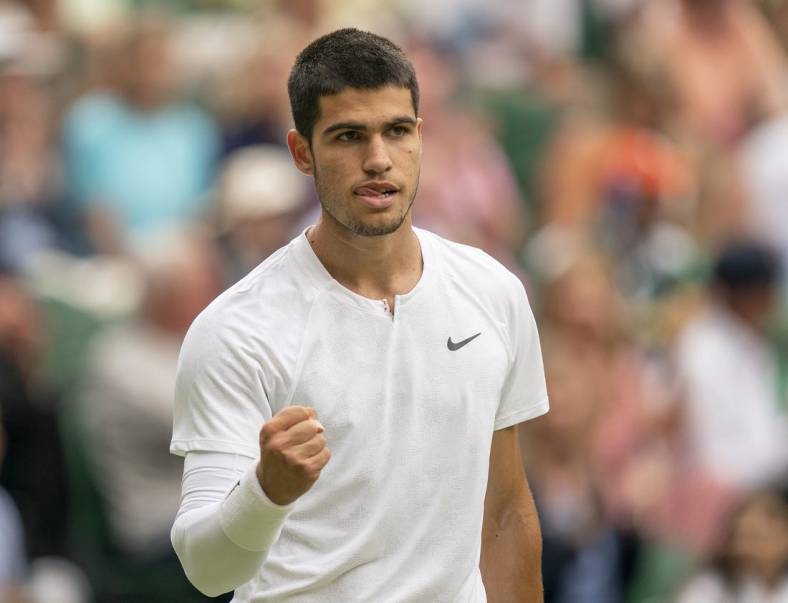 Jul 3, 2022; London, United Kingdom; Carlos Alcaraz (ESP) reacts to a point during his match against Jannik Sinner (ITA) on day seven at All England Lawn Tennis and Croquet Club. Mandatory Credit: Susan Mullane-USA TODAY Sports