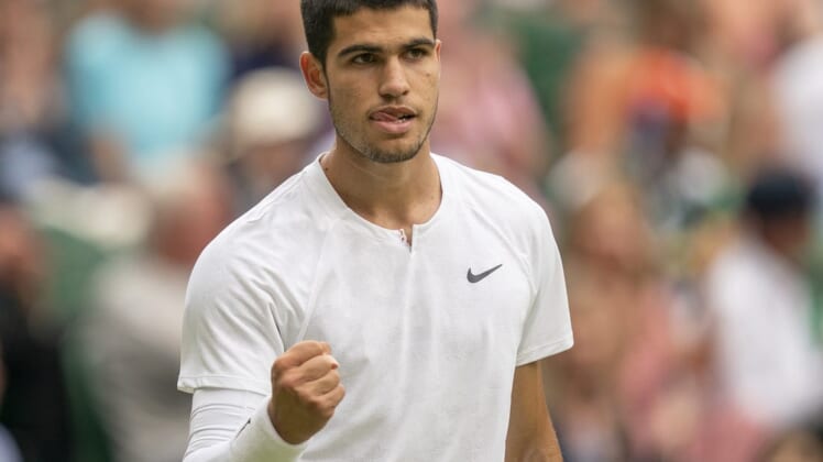 Jul 3, 2022; London, United Kingdom; Carlos Alcaraz (ESP) reacts to a point during his match against Jannik Sinner (ITA) on day seven at All England Lawn Tennis and Croquet Club. Mandatory Credit: Susan Mullane-USA TODAY Sports