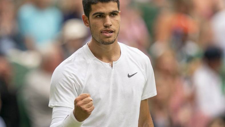 Jul 3, 2022; London, United Kingdom; Carlos Alcaraz (ESP) reacts to a point during his match against Jannik Sinner (ITA) on day seven at All England Lawn Tennis and Croquet Club. Mandatory Credit: Susan Mullane-USA TODAY Sports