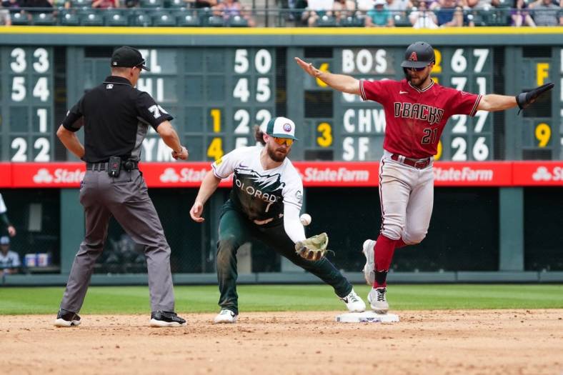 Jul 3, 2022; Denver, Colorado, USA; Colorado Rockies second baseman Brendan Rodgers (7) is unable to field the ball as Arizona Diamondbacks designated hitter Cooper Hummel (21 advances to second in the sixth inning at Coors Field. Mandatory Credit: Ron Chenoy-USA TODAY Sports