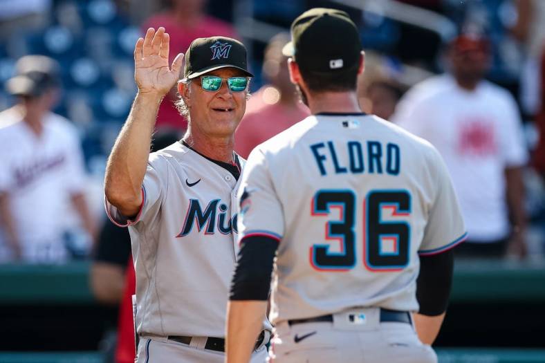 Jul 3, 2022; Washington, District of Columbia, USA; Miami Marlins manager Don Mattingly (8) and relief pitcher Dylan Floro (36) celebrate after the game against the Washington Nationals at Nationals Park. Mandatory Credit: Scott Taetsch-USA TODAY Sports