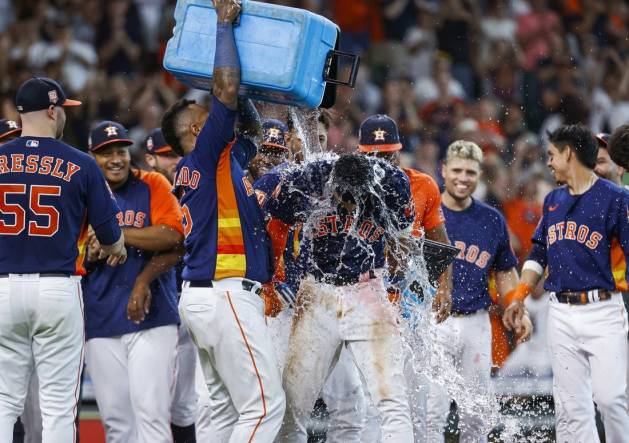 Jul 3, 2022; Houston, Texas, USA; Houston Astros shortstop Jeremy Pena (3) has water poured on his head by catcher Martin Maldonado (15) after hitting a walk-off home run during the ninth inning against the Los Angeles Angels at Minute Maid Park. Mandatory Credit: Troy Taormina-USA TODAY Sports