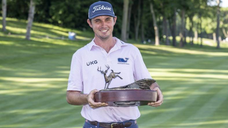 Jul 3, 2022; Silvis, Illinois, USA; J.T. Poston holds the John Deere Classic trophy after winning the John Deere Classic golf tournament. Mandatory Credit: Marc Lebryk-USA TODAY Sports